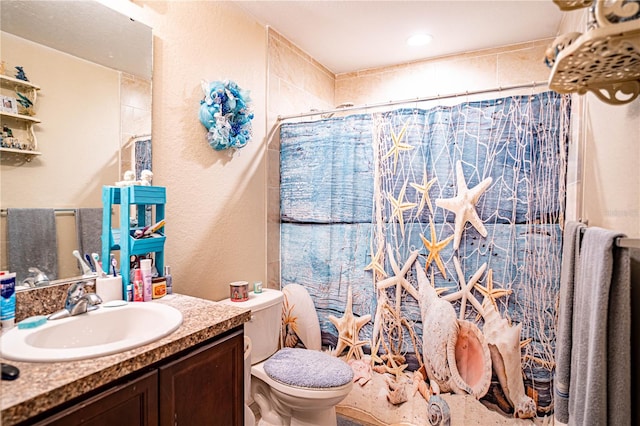 bathroom with a shower with curtain, vanity, and toilet