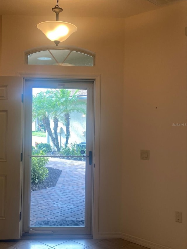 doorway to outside with light tile patterned floors