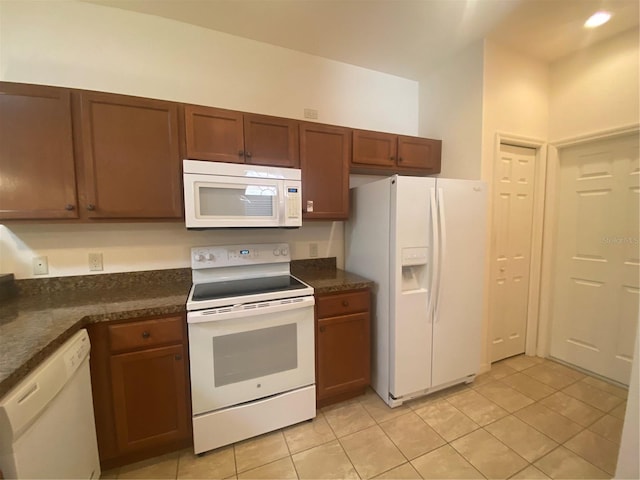 kitchen featuring light tile patterned flooring and white appliances