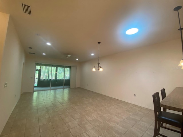 spare room with an inviting chandelier