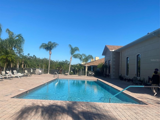 view of swimming pool featuring a patio area