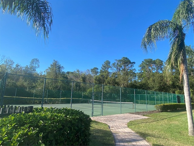 view of sport court featuring a yard