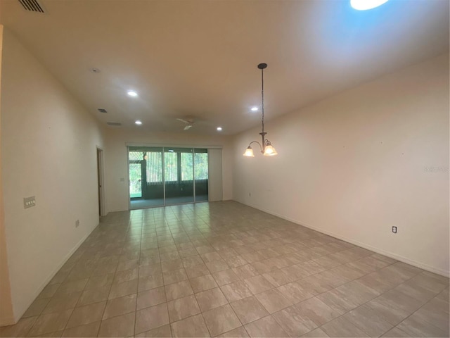 empty room featuring an inviting chandelier