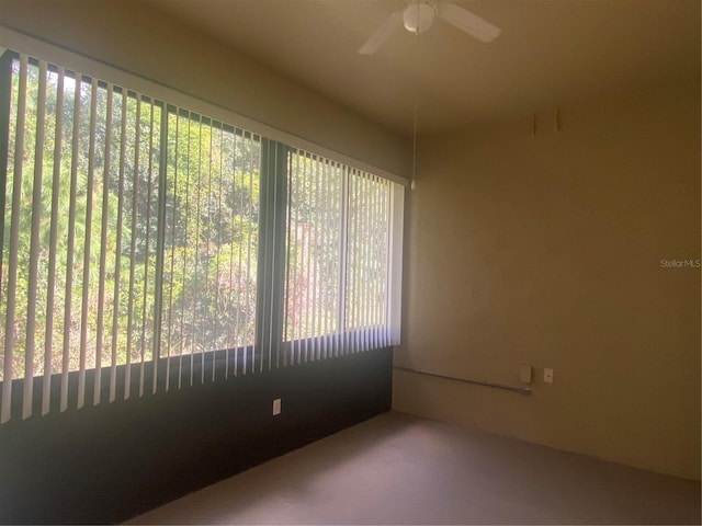 carpeted spare room with ceiling fan