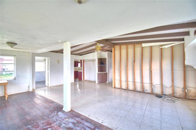 interior space featuring lofted ceiling with beams and ceiling fan