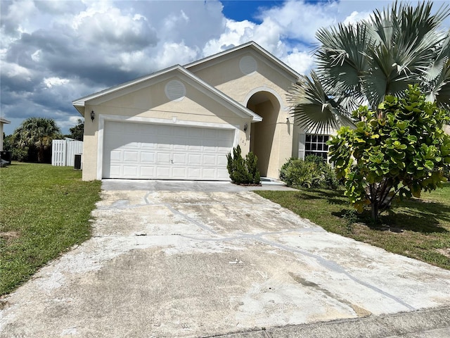 ranch-style home with a garage and a front lawn