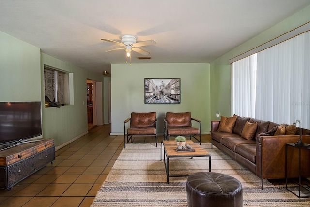 living room with tile patterned flooring and ceiling fan