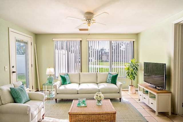 tiled living room with ceiling fan