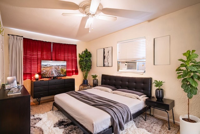 carpeted bedroom with ceiling fan and cooling unit