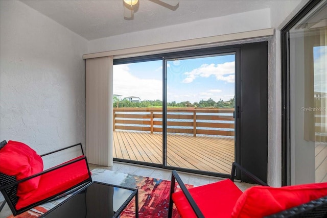 interior space with ceiling fan