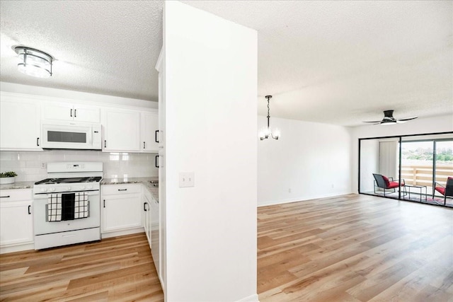 kitchen with backsplash, white cabinetry, light hardwood / wood-style floors, and white appliances