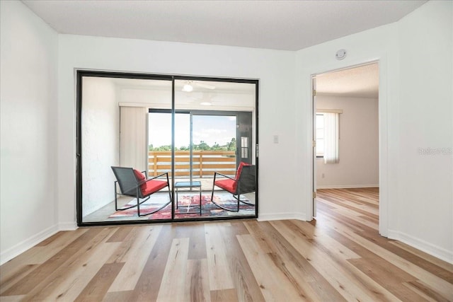 doorway to outside featuring a textured ceiling and light hardwood / wood-style flooring