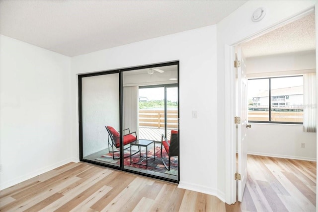 unfurnished room with a textured ceiling and light hardwood / wood-style floors