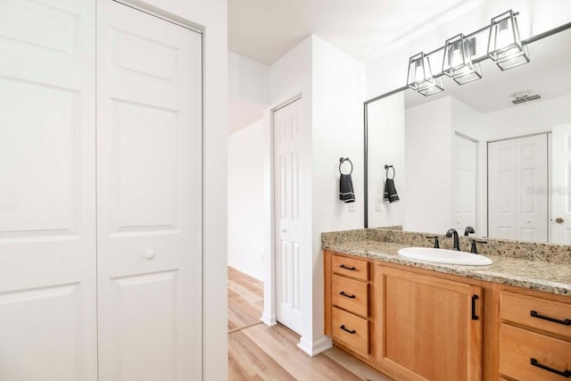 bathroom with vanity and hardwood / wood-style flooring