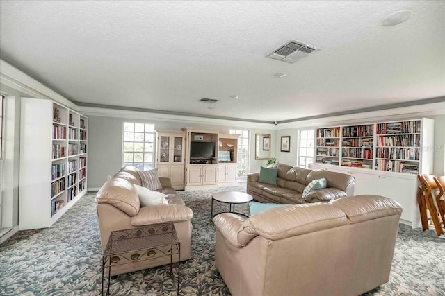 carpeted living room with crown molding and a textured ceiling