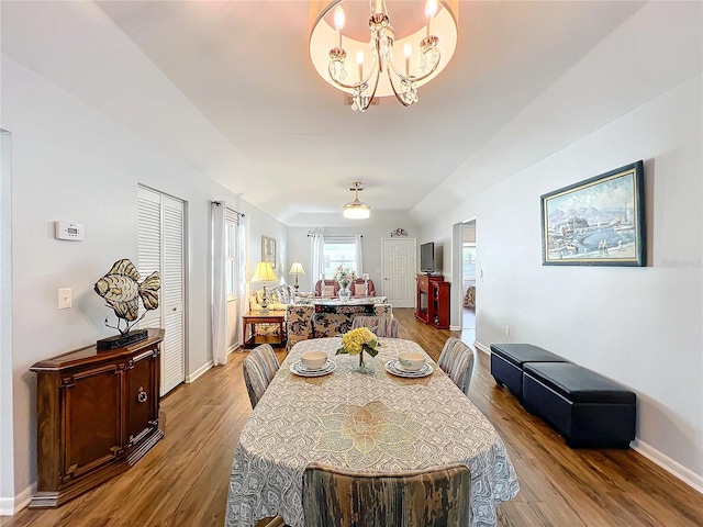 dining space with a notable chandelier and light wood-type flooring