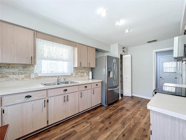 kitchen with light brown cabinets, sink, stainless steel refrigerator with ice dispenser, tasteful backsplash, and dark hardwood / wood-style flooring