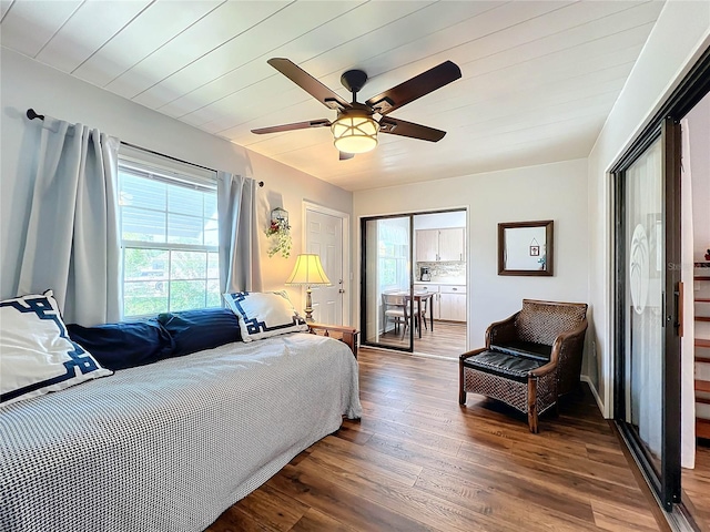 bedroom featuring hardwood / wood-style floors, ceiling fan, and multiple windows