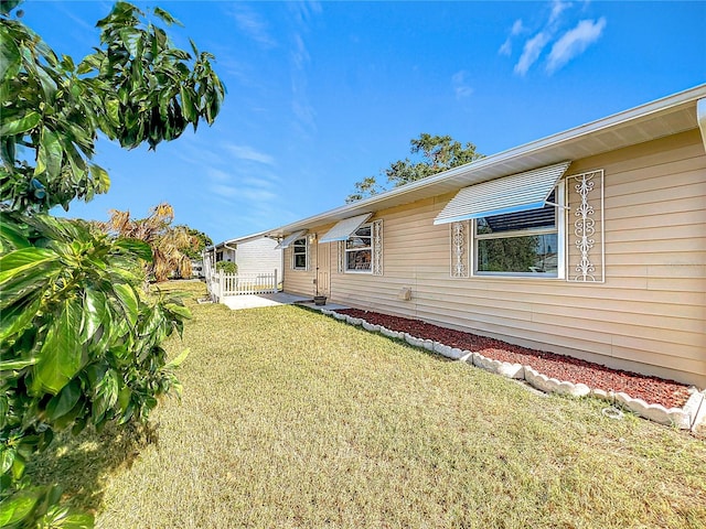 rear view of property featuring a yard