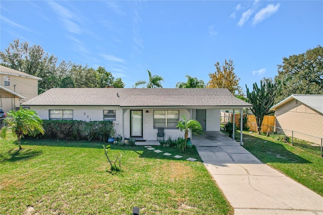 ranch-style home featuring a front yard and a carport