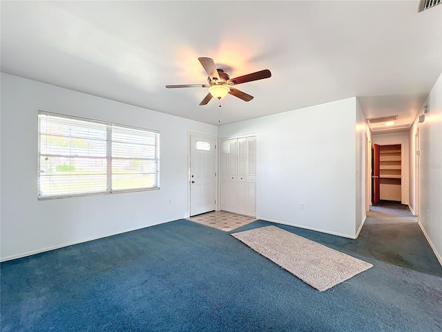 spare room with carpet flooring and ceiling fan