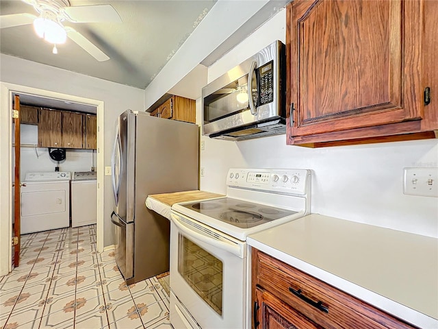 kitchen featuring ceiling fan, washing machine and dryer, and appliances with stainless steel finishes