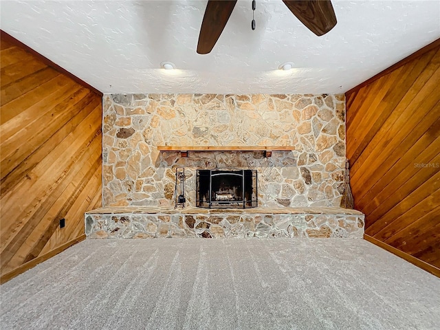 221 Dorothy St, Auburndale, FL 33823 - detailed view of wood walls, carpet floors, a ceiling fan, and a stone fireplace
