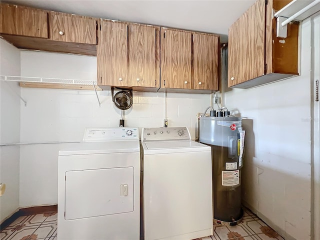 washroom with washer and dryer, electric water heater, and cabinets