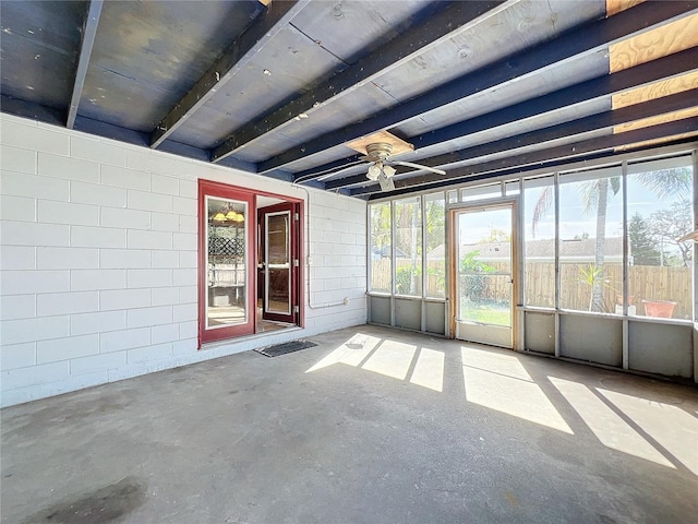 unfurnished sunroom with ceiling fan