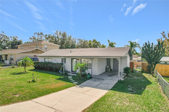 ranch-style house with a front yard and a carport