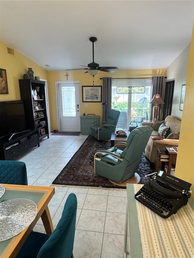 living room featuring a wealth of natural light, light tile patterned flooring, and ceiling fan