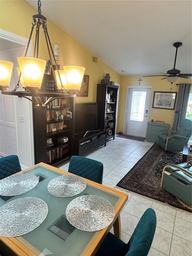 dining area featuring ceiling fan, light tile patterned floors, and lofted ceiling