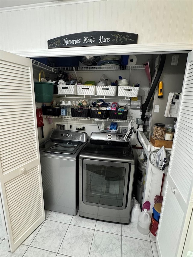 washroom with washing machine and dryer and light tile patterned floors