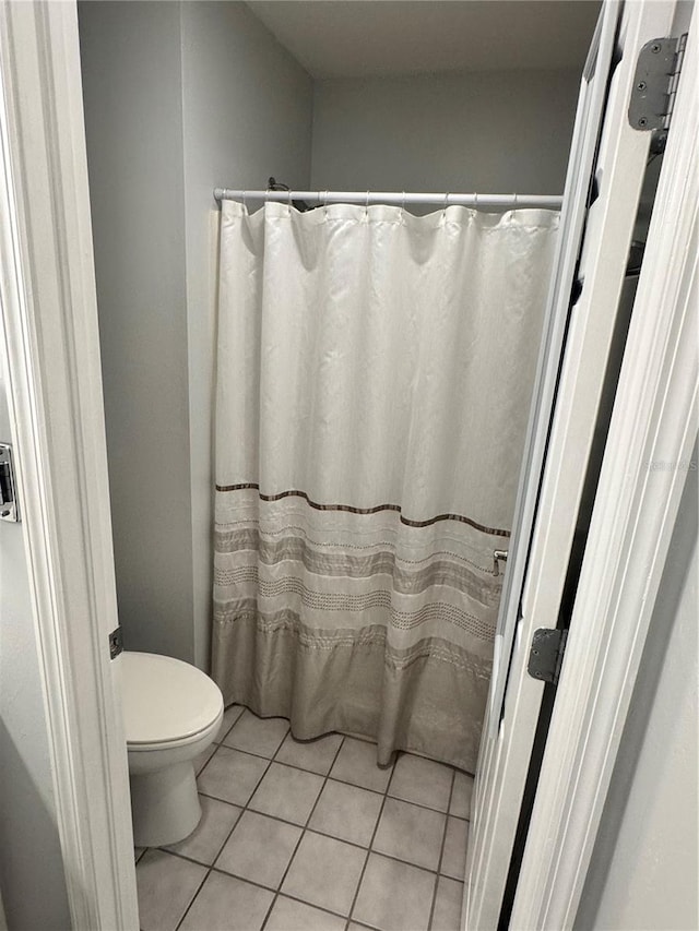 bathroom with tile patterned floors and toilet