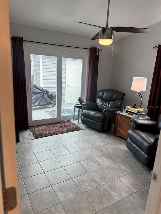 living room with ceiling fan and light tile patterned flooring