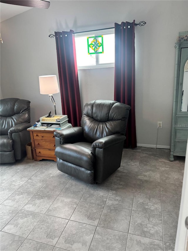 tiled living room with ceiling fan