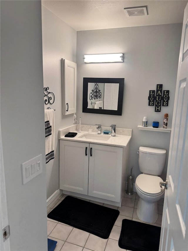 bathroom featuring tile patterned floors, vanity, and toilet