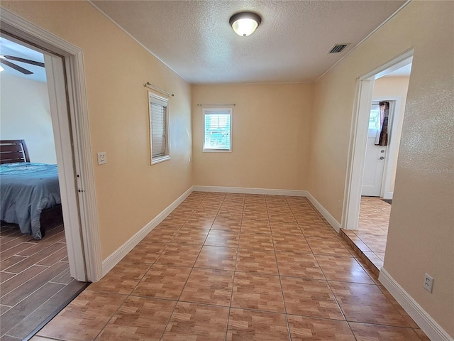 hallway with a textured ceiling