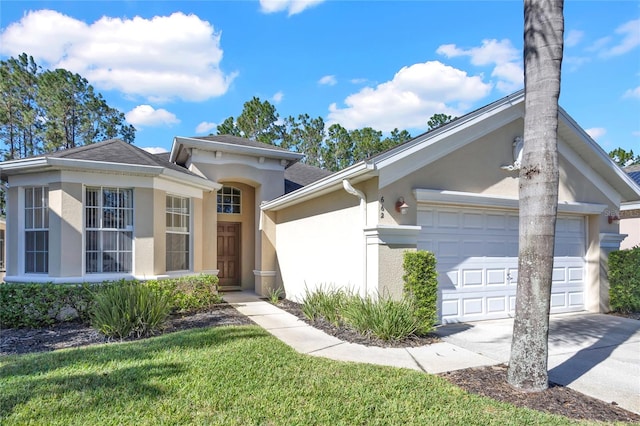 view of front facade with a garage and a front lawn