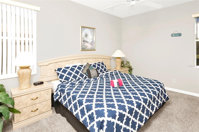 bedroom featuring ceiling fan and carpet