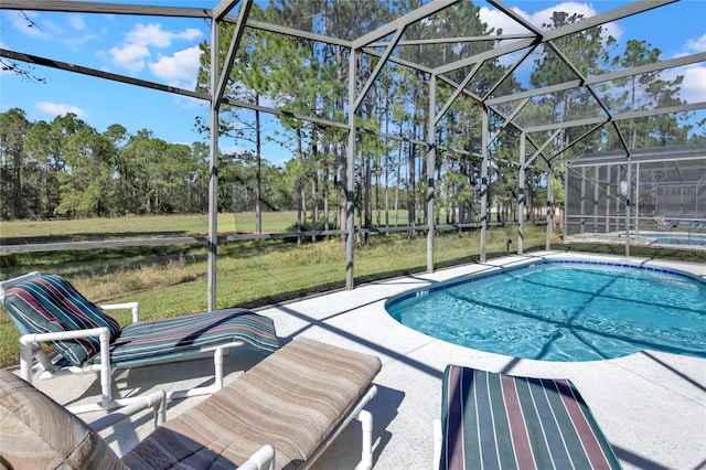 view of swimming pool featuring a lanai, a patio area, and a yard