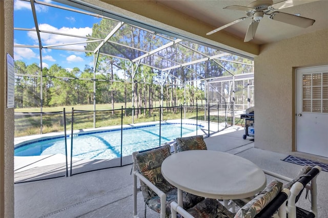 view of pool with a lanai, ceiling fan, and a patio area