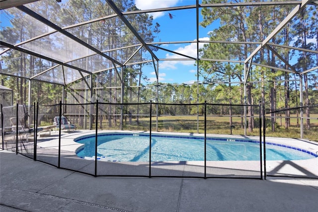 view of swimming pool featuring a lanai and a patio area