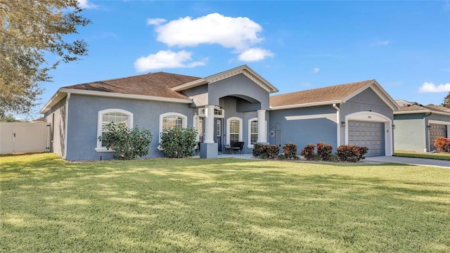 view of front of house featuring a garage and a front lawn