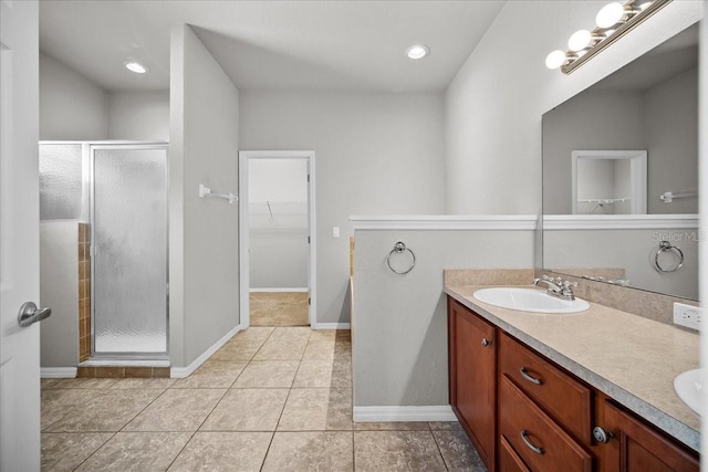 bathroom with vanity, a shower with shower door, and tile patterned flooring