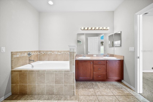 bathroom with vanity, tiled bath, and tile patterned floors