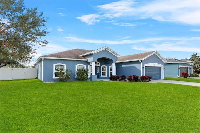 ranch-style house with a garage and a front yard