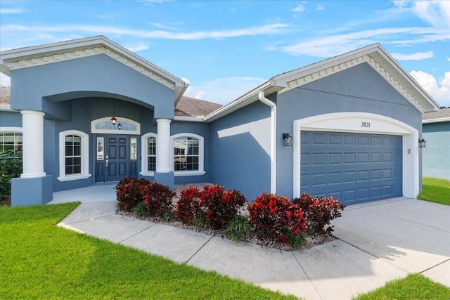 view of front of house with a garage and a front yard