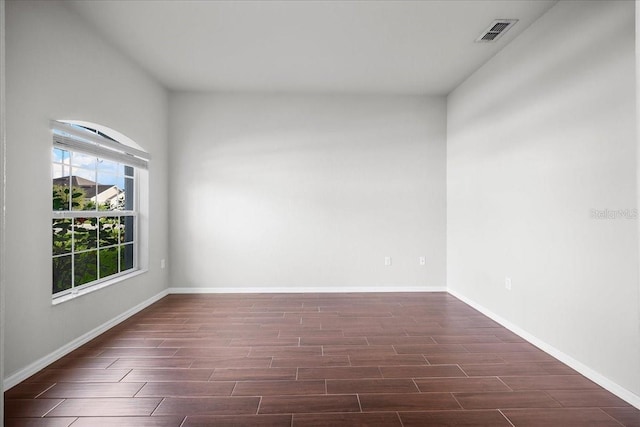 spare room with dark wood-type flooring