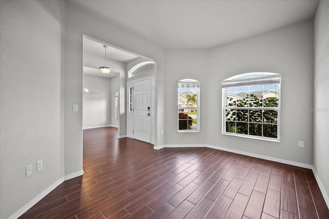 empty room with dark hardwood / wood-style flooring